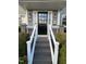 Charming home featuring a well-lit front entrance with decorative sidelights and a Welcome mat at 627 New Road, Raleigh, NC 27608