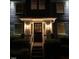 Illuminated front entrance with a classic door and manicured shrubs at 627 New Road, Raleigh, NC 27608