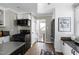 Bright and open kitchen featuring stainless steel appliances, black countertops, and tile flooring at 627 New Road, Raleigh, NC 27608