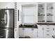 Bright kitchen featuring white cabinetry, a stainless steel refrigerator, and a window with lots of natural light at 627 New Road, Raleigh, NC 27608