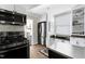Bright kitchen featuring modern appliances, and view into another room at 627 New Road, Raleigh, NC 27608