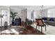 Bright living room featuring a plant, hardwood floors, and a comfortable sofa at 627 New Road, Raleigh, NC 27608