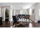 Well-lit living room with a comfortable sofa, a patterned chair, and hardwood floors at 627 New Road, Raleigh, NC 27608