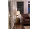 Cozy living room featuring hardwood floors, a modern lamp and chair, and plenty of natural light at 627 New Road, Raleigh, NC 27608