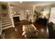 Cozy living room with hardwood floors, a fireplace, stairs, and neutral paint at 627 New Road, Raleigh, NC 27608