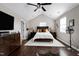 A spacious bedroom featuring a bed with a cushioned headboard, hardwood floors, and a vaulted ceiling at 627 New Road, Raleigh, NC 27608