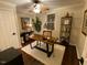 Bright home office with a rustic wooden desk, a ceiling fan, and a comfortable chair at 627 New Road, Raleigh, NC 27608