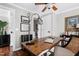 Well-lit home office featuring a rustic wooden desk, a laptop, and comfortable chair at 627 New Road, Raleigh, NC 27608