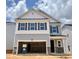 Charming two-story home showcasing a covered entryway, two-car garage, and beautiful architectural details at 709 Emerald Bay Cir # 833, Raleigh, NC 27610