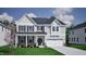 Charming two-story home featuring gray siding, a covered front porch, and an attached two-car garage at 75 Guardian St, Youngsville, NC 27596