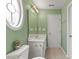 Bathroom with an oval window, a toilet, a neutral floor, and a bright vanity with sink at 7856 Spungold St, Raleigh, NC 27617