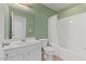 Bathroom featuring a tub and shower combination, bright vanity, and neutral tile at 7856 Spungold St, Raleigh, NC 27617