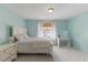 Bedroom with blue walls, plush carpet, a queen size bed, night stand and sunny window views at 7856 Spungold St, Raleigh, NC 27617