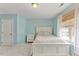 Bedroom with blue walls, plush carpet, a queen size bed, night stand and sunny window views at 7856 Spungold St, Raleigh, NC 27617