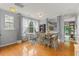 Bright dining area features hardwood floors, a work station, and views into the kitchen and outdoor deck at 7856 Spungold St, Raleigh, NC 27617