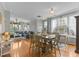Inviting dining area with hardwood floors, stylish furniture, and large windows for plenty of natural light at 7856 Spungold St, Raleigh, NC 27617