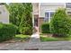 Welcoming entrance with brick accents, garden, and a well-manicured lawn at 7856 Spungold St, Raleigh, NC 27617