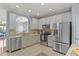 Bright kitchen with stainless steel appliances, tiled backsplash, and an open layout at 7856 Spungold St, Raleigh, NC 27617
