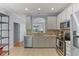Modern kitchen featuring stainless steel appliances, granite countertops, and an open layout to the living room at 7856 Spungold St, Raleigh, NC 27617