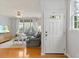 Bright living room featuring hardwood floors, ceiling fan, and natural light at 7856 Spungold St, Raleigh, NC 27617