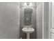 The powder room features modern fixtures and a clean design at 7856 Spungold St, Raleigh, NC 27617