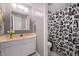 Cozy bathroom with a vanity, mirror, and a charming animal-themed shower curtain at 7916 Foxwood Dr, Raleigh, NC 27615