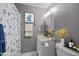 Cozy bathroom featuring vanity with framed art, light fixture and neutral paint at 7916 Foxwood Dr, Raleigh, NC 27615