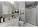 Bathroom featuring modern fixtures, a walk-in shower, and a vanity with ample counter space at 7916 Foxwood Dr, Raleigh, NC 27615