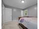 Bedroom featuring neutral walls, carpet, and a bed accented by natural light from the window at 7916 Foxwood Dr, Raleigh, NC 27615