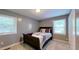 Bedroom with a queen bed, two windows, and neutral carpet at 7916 Foxwood Dr, Raleigh, NC 27615