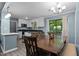 Cozy dining area featuring a large table, chairs, and a seamless transition to the kitchen at 7916 Foxwood Dr, Raleigh, NC 27615