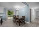Well-lit dining room with wood floors, chandelier, table and chairs near sliding glass doors at 7916 Foxwood Dr, Raleigh, NC 27615