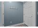 Cozy entryway featuring beadboard walls, coat hooks, and a freshly painted front door at 7916 Foxwood Dr, Raleigh, NC 27615
