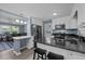 Kitchen with stainless steel appliances, granite countertops, a breakfast bar, and white cabinetry at 7916 Foxwood Dr, Raleigh, NC 27615