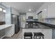 Kitchen featuring stainless steel appliances, a breakfast bar with seating, and white cabinetry at 7916 Foxwood Dr, Raleigh, NC 27615