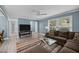 Relaxing living area featuring a large sectional, modern entertainment center, and a view to the outdoors at 7916 Foxwood Dr, Raleigh, NC 27615