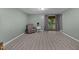 Bright living room leads to the back patio through glass doors and neutral paint at 7916 Foxwood Dr, Raleigh, NC 27615