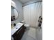 Cozy bathroom featuring a modern vanity, round mirror, and shower with stylish curtain at 80 Stoneridge Rd, Durham, NC 27705
