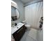 Cozy bathroom featuring a modern vanity, round mirror, and shower with stylish curtain at 80 Stoneridge Rd, Durham, NC 27705