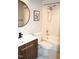 Bathroom features a wood vanity, modern fixtures, and a shower over tub with tile surround at 80 Stoneridge Rd, Durham, NC 27705