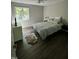 Bright bedroom with a ceiling fan, large window, and dark wood floors at 80 Stoneridge Rd, Durham, NC 27705