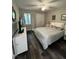 Comfortable bedroom with white bedding, dark wood floors, and ample natural light at 80 Stoneridge Rd, Durham, NC 27705