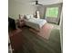 Cozy bedroom with a pink area rug and natural light from large window at 80 Stoneridge Rd, Durham, NC 27705