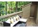 Relaxing deck area featuring comfortable seating and a charming view of the surrounding greenery at 80 Stoneridge Rd, Durham, NC 27705