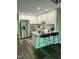 Bright kitchen with an island, stainless steel appliances, white cabinets, and modern fixtures at 80 Stoneridge Rd, Durham, NC 27705