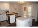 Bright kitchen featuring white cabinets, quartz countertops and a large island with a breakfast bar at 80 Stoneridge Rd, Durham, NC 27705