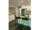 Modern kitchen with stainless steel appliances, white cabinets, an island and seating at 80 Stoneridge Rd, Durham, NC 27705