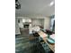 Open kitchen and living room with modern appliances, island seating, and fireplace at 80 Stoneridge Rd, Durham, NC 27705