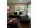 Inviting living room with dark sofa, patterned pillows, and access to outdoor deck at 80 Stoneridge Rd, Durham, NC 27705