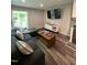 Comfortable living room features a modern sectional sofa and flat-screen TV at 80 Stoneridge Rd, Durham, NC 27705